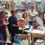 Claytopia's Painting Class Group Smiling Holding Painted Pieces