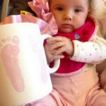 Adorable Baby Holding a Footprinted Mug